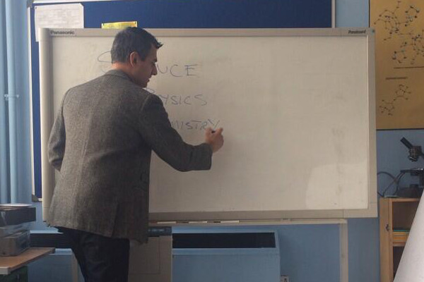 Kal Sabir as Mr Malik at whiteboard.